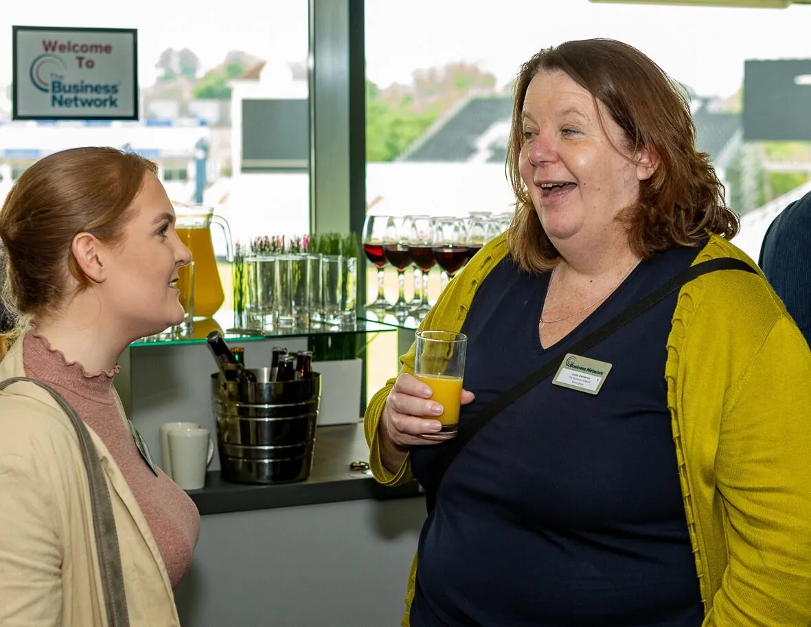 Julie talking to member at event